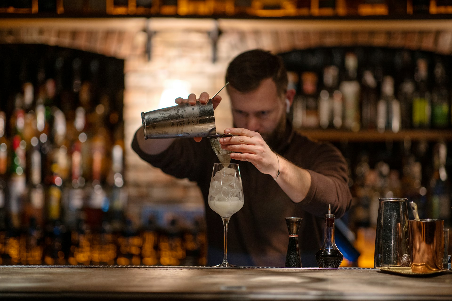 Bartender making a drink at a bar