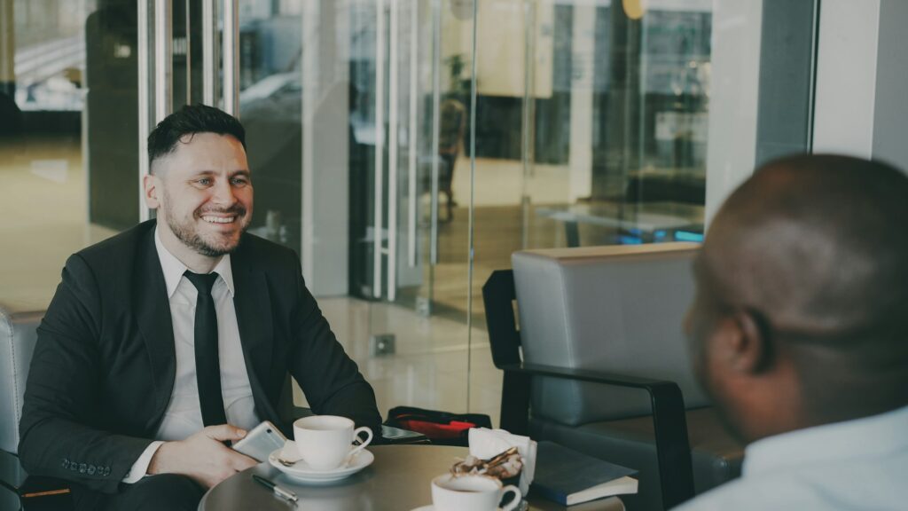 Hospitality consultant meeting a business owner in a cafe