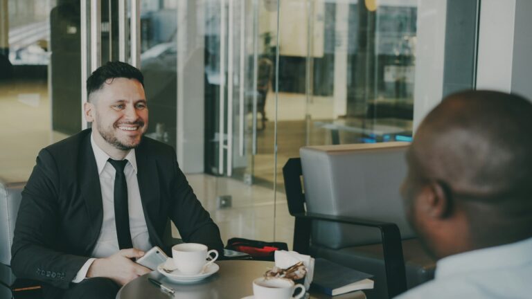 Hospitality consultant meeting a business owner in a cafe