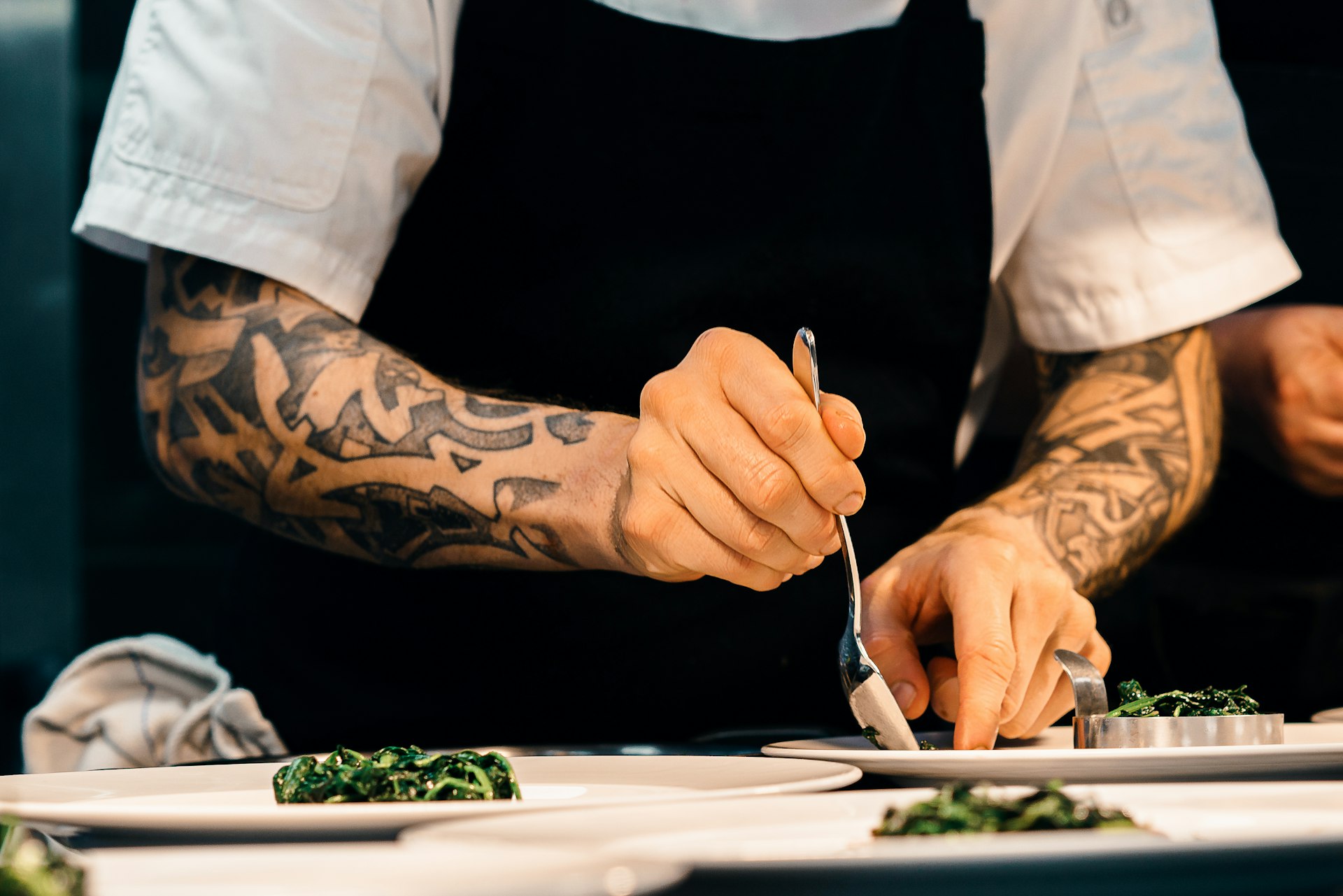 Chef plating a dish in a restaurant kitchen